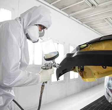 Collision Center Technician Painting a Vehicle | Janzen Toyota in Stillwater OK