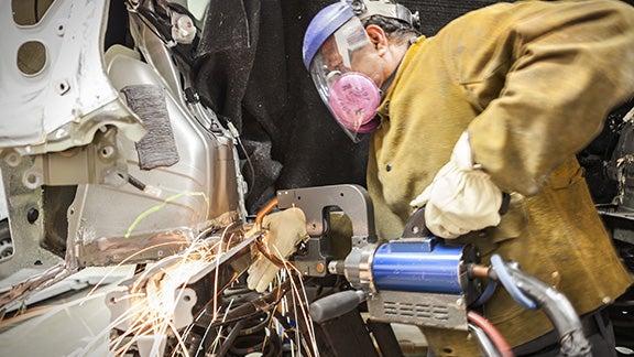 Collision Center Technician Repairing Vehicle | Janzen Toyota in Stillwater OK